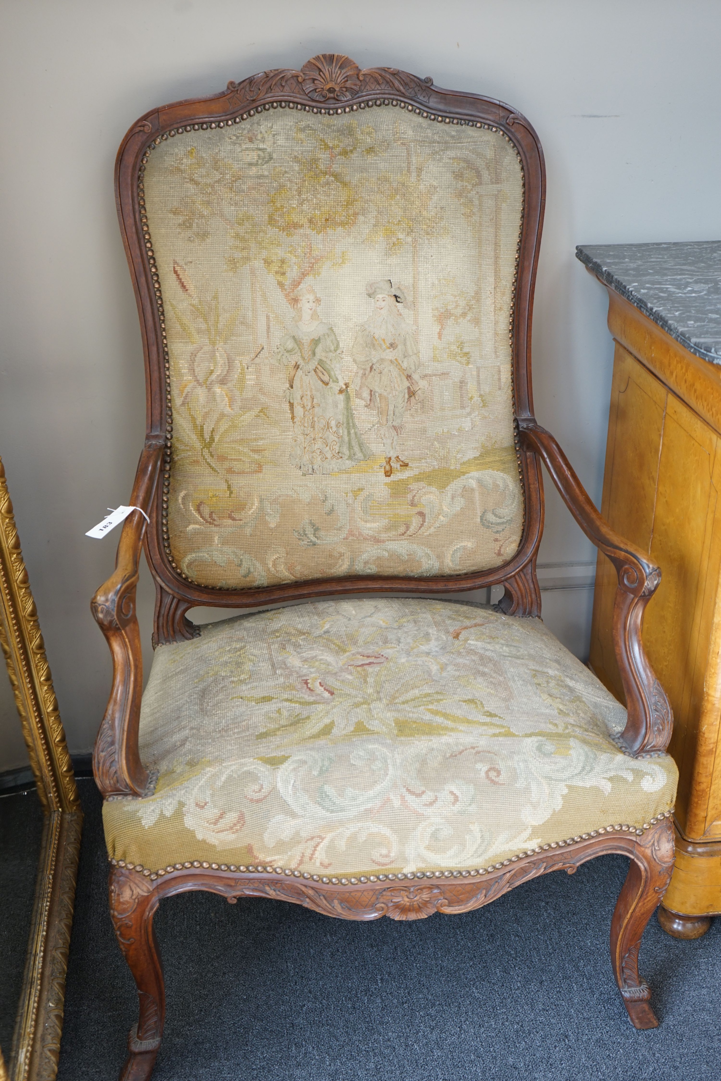 A pair of French carved walnut fauteuils with tapestry upholstery, width 75cm, depth 62cm, height 120cm